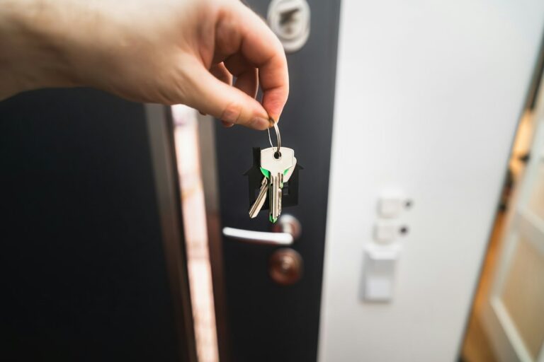 Key in the front door lock of a house, representing a negotiated purchase from a motivated seller