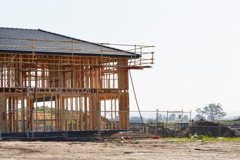 House with exposed wood framing under construction, illustrating a fix and flip renovation