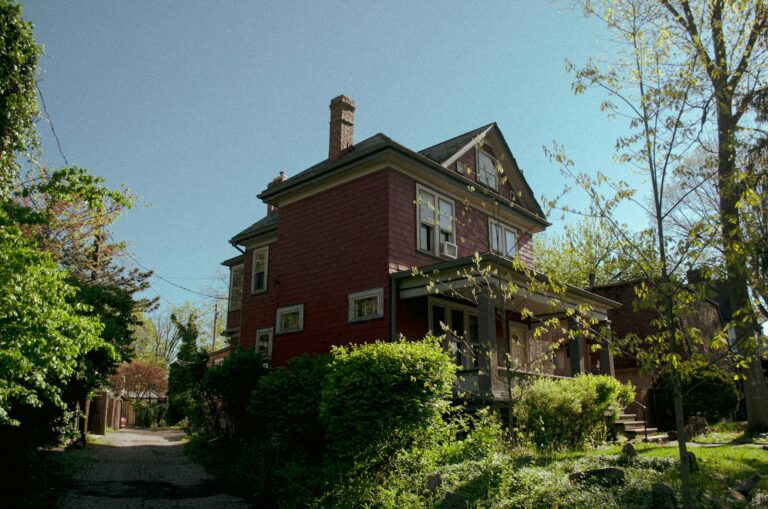 Brick single-family house on a tree-lined street, the kind of home that moves through the Ohio foreclosure timeline