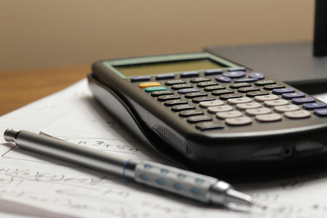 Calculator and pen on a worksheet for calculating cash on cash return on a rental property