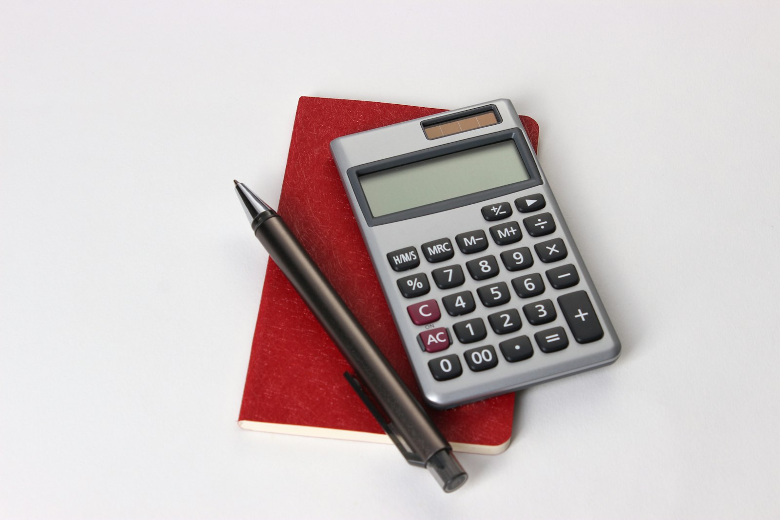 Calculators, pens and notebooks on an office desk for working out a loan to value ratio