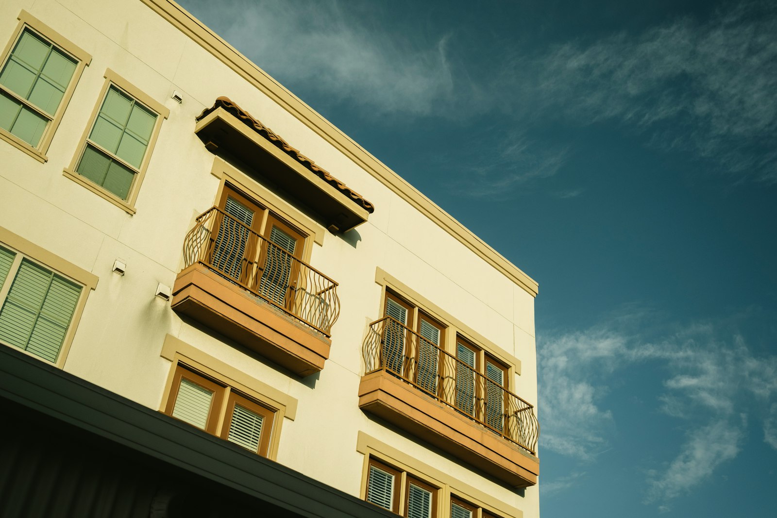 Cream-colored condo building with balconies, where buyers request an estoppel letter from the association