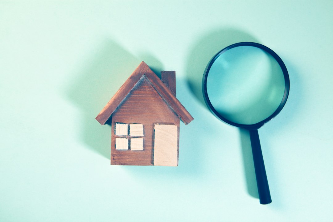 House model and magnifying glass, representing a buyer's review during an inspection contingency
