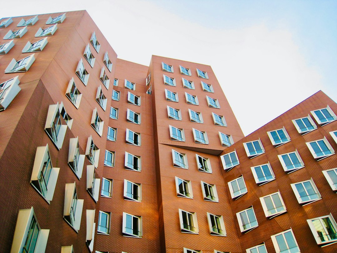 Mid-size apartment building on a tree-lined street, illustrating how investors measure equity multiple in real estate