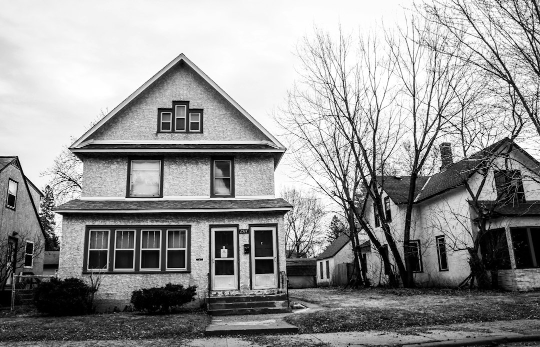 Post-war single-family house on a quiet street, the kind of home a lender may take back through a deed in lieu of foreclosure