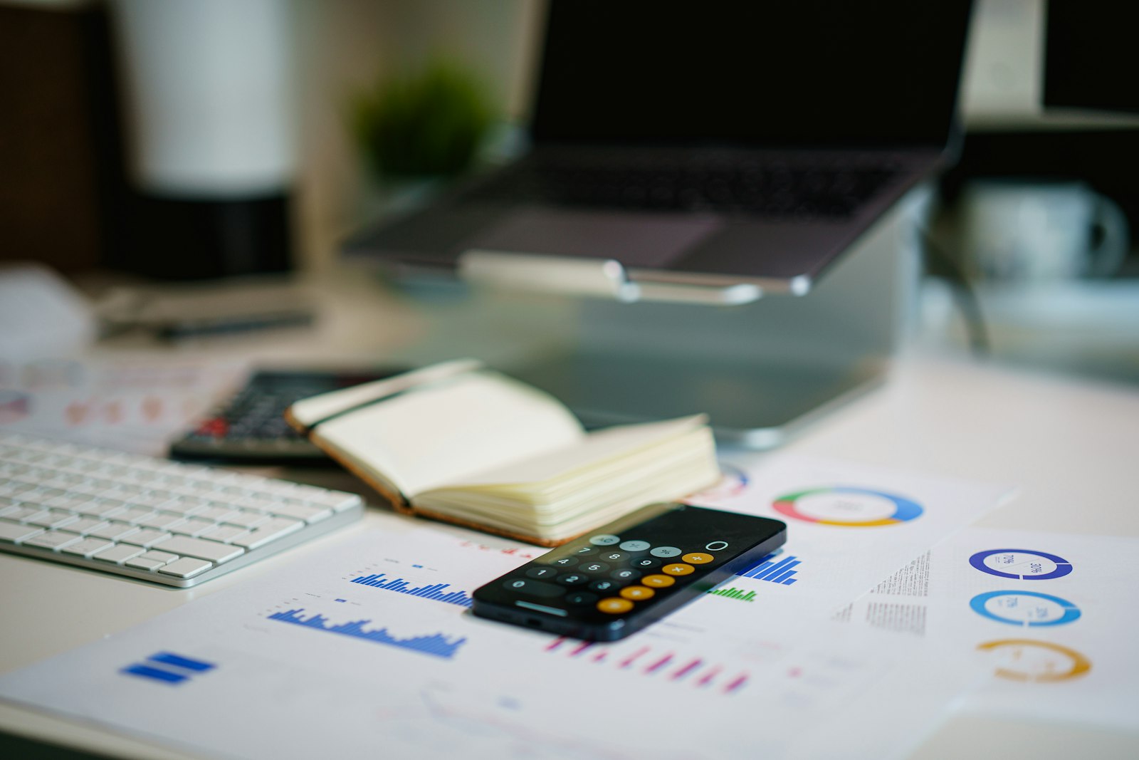 Real estate acquisition manager reviewing deal numbers and reports on a laptop