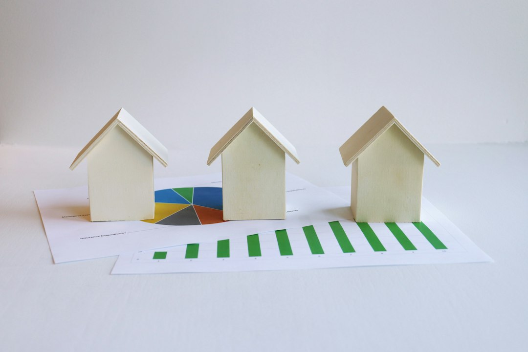 Three small model houses on a sheet of paper, illustrating equitable interest in real estate under a purchase contract