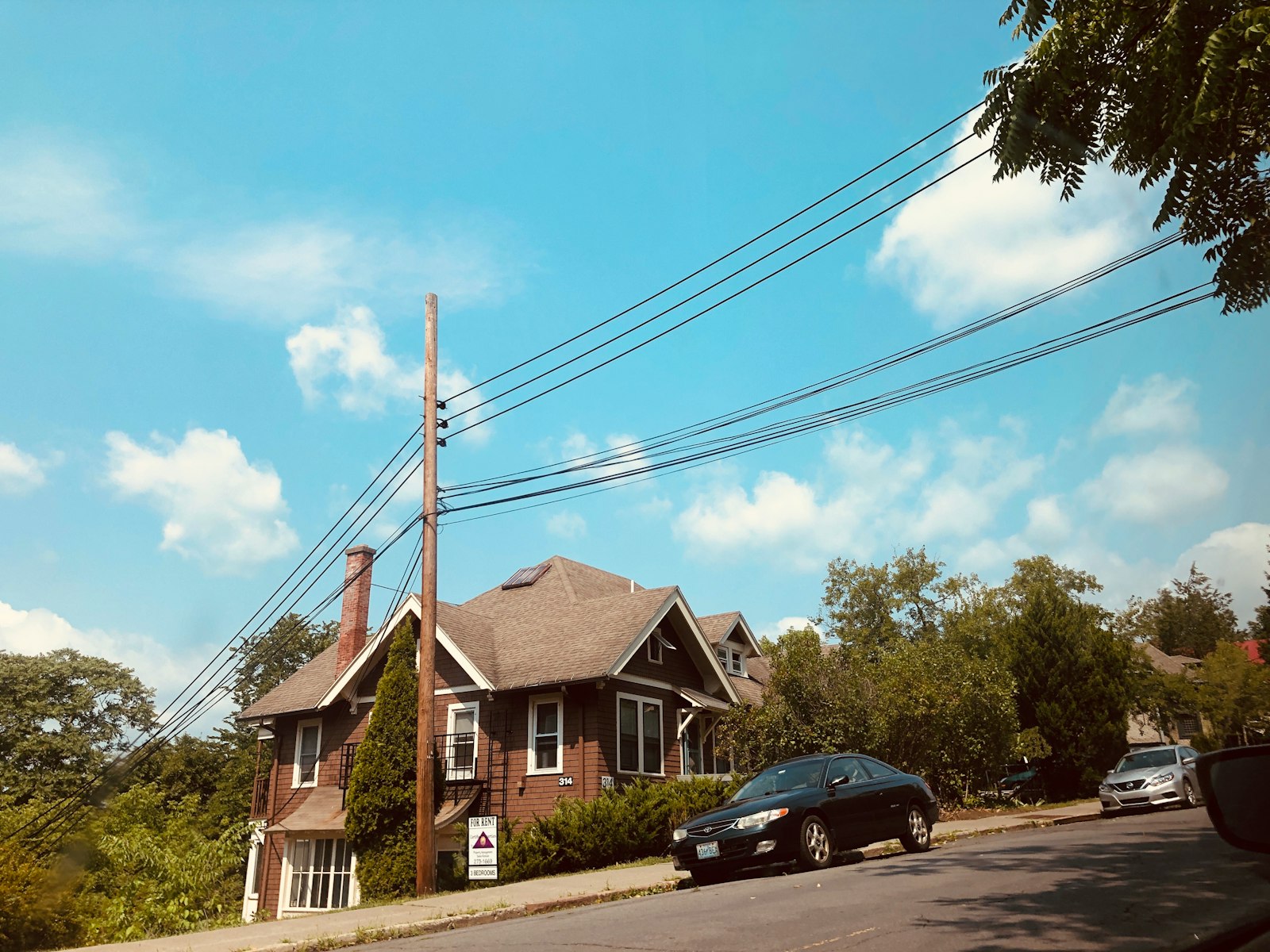 Small single-family rental house on a sunny day, valued with a gross rent multiplier
