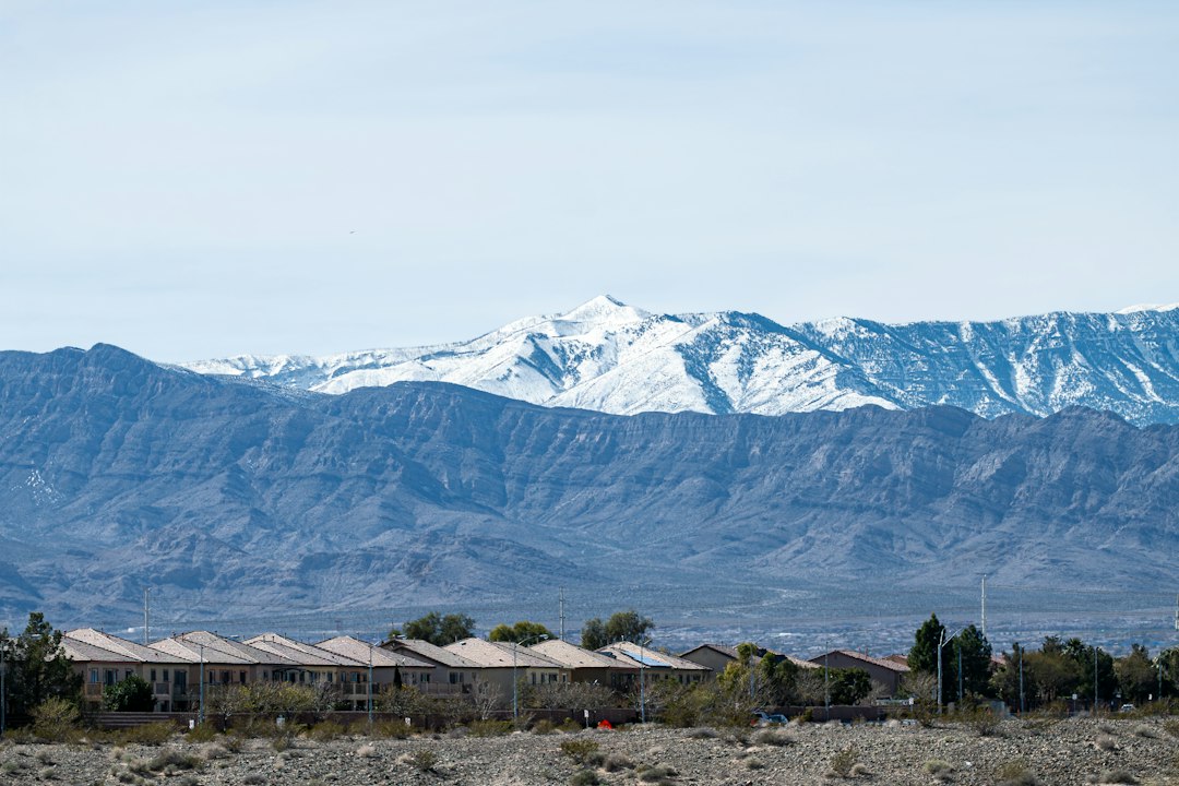 Row of suburban homes under a mountain sky, illustrating the Colorado foreclosure process for real estate investors