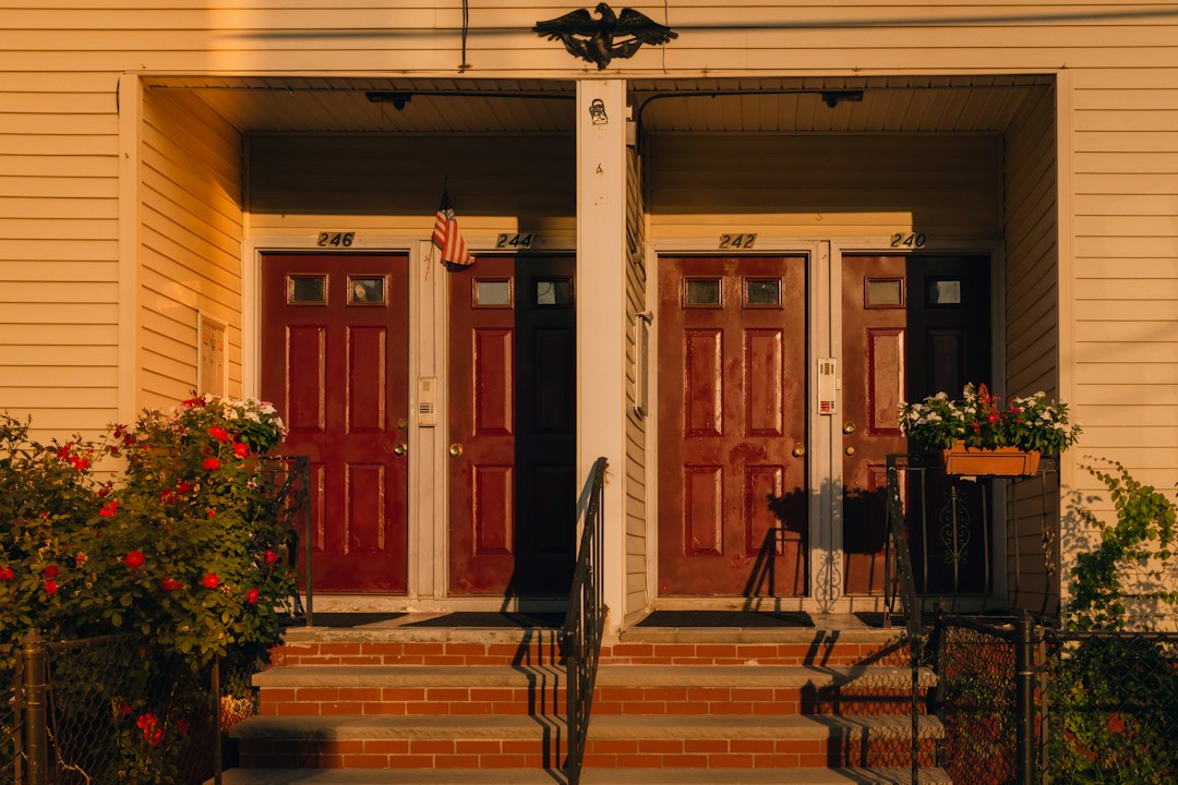 Two matching buildings with red doors, symbolizing co-owners splitting property in a partition action